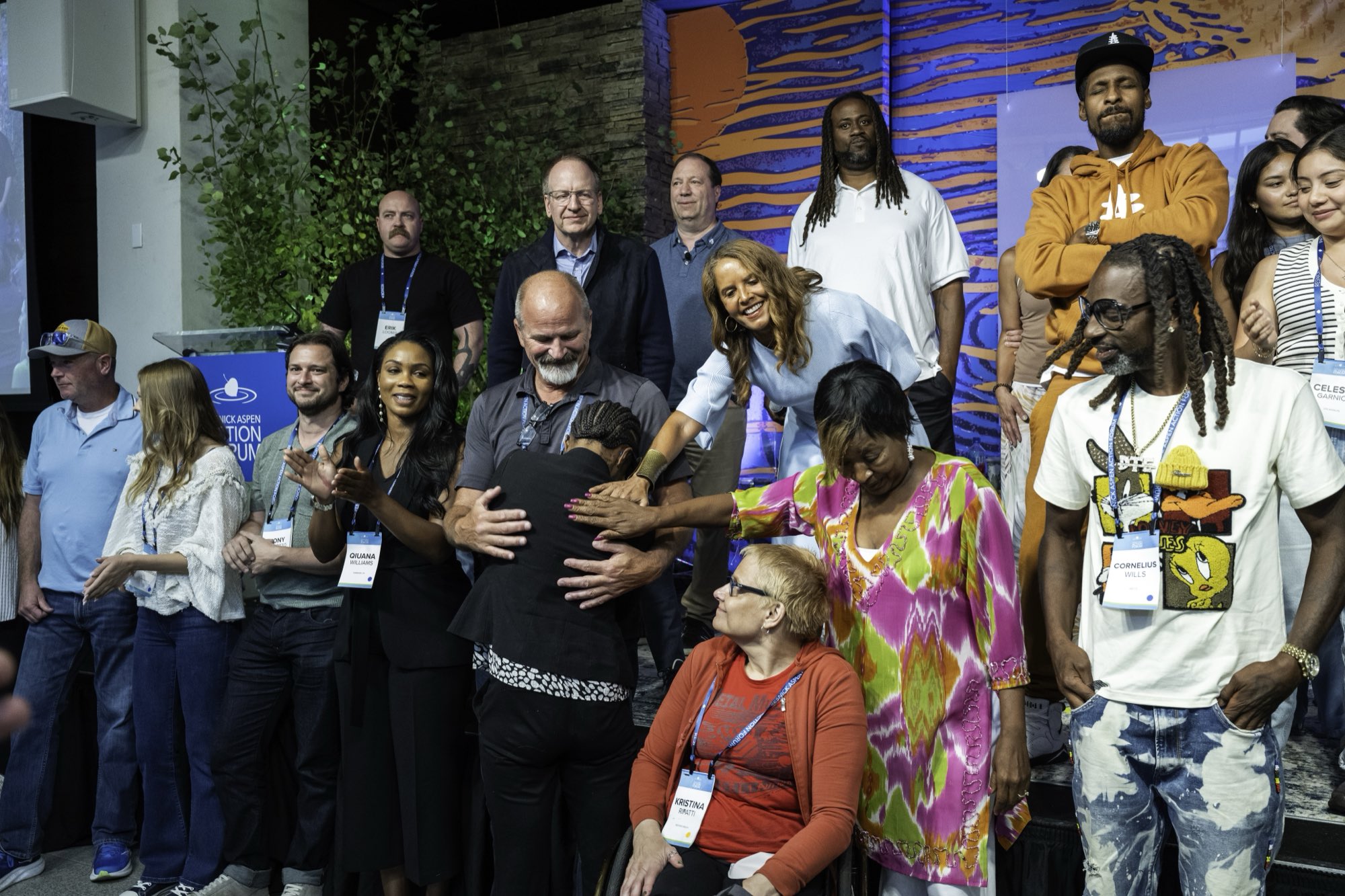 Filmmakers, police, families and residents together on stage at the close of the Aspen Ideas Festival plenary, one woman reaching across to embrace another