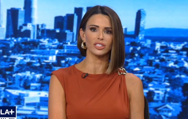 A FOX 11 Good Day LA anchor introducing the segment, downtown Los Angeles behind her